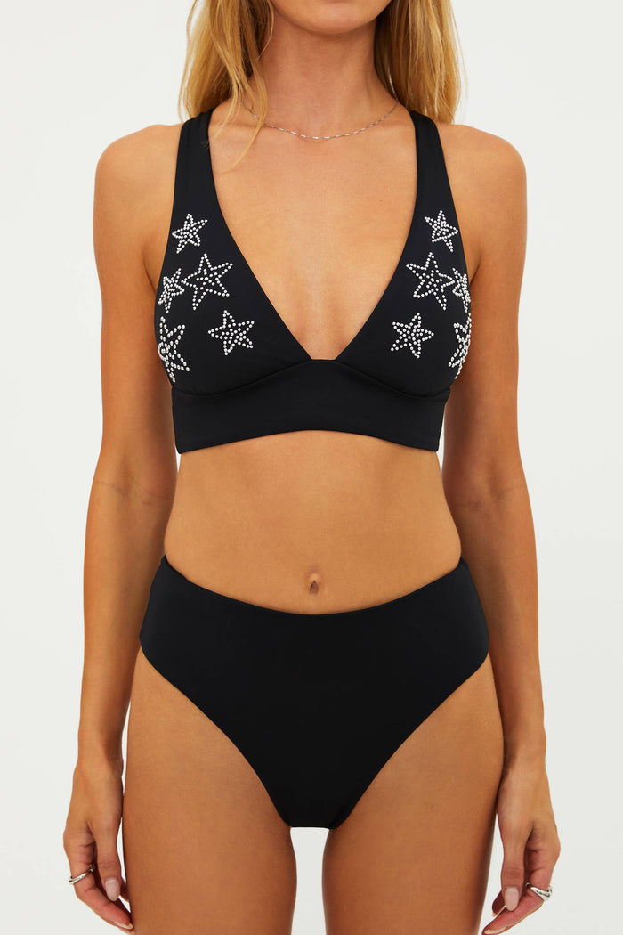 Black bikini set with star patterns on a white background