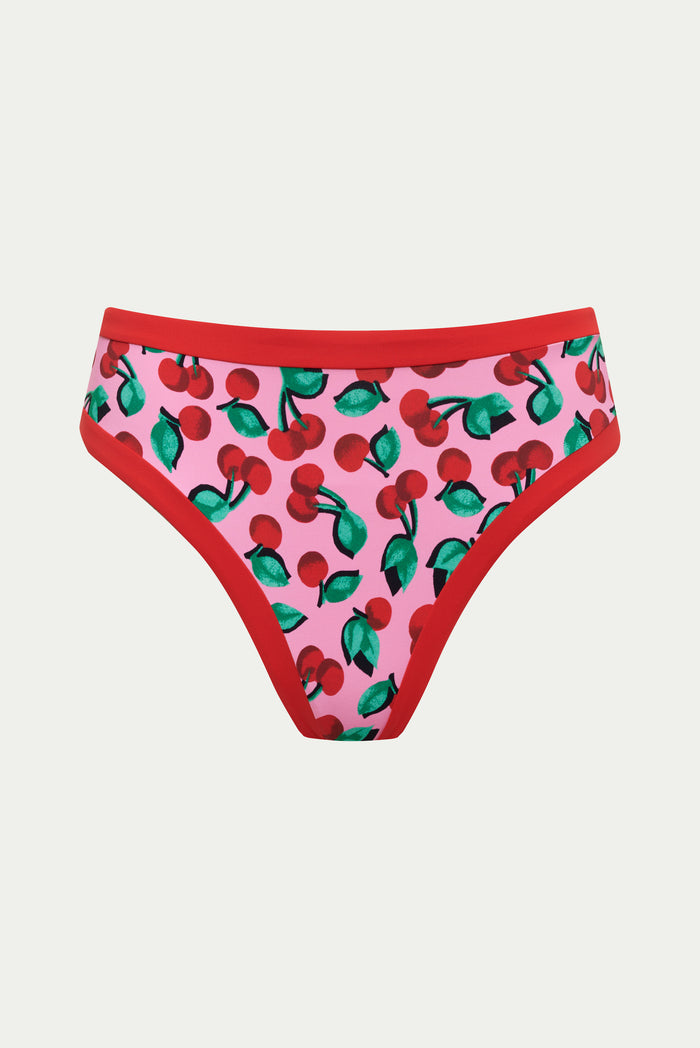 Pink bikini bottom with cherry pattern on a white background