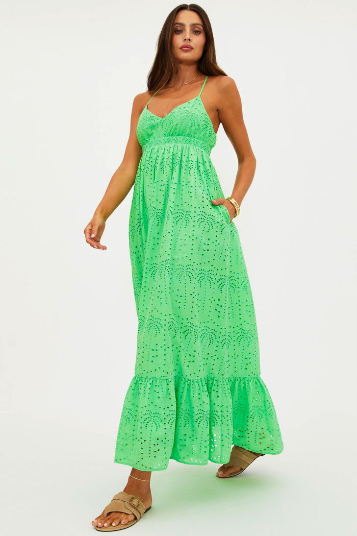 Woman wearing a green lace maxi dress on a white background