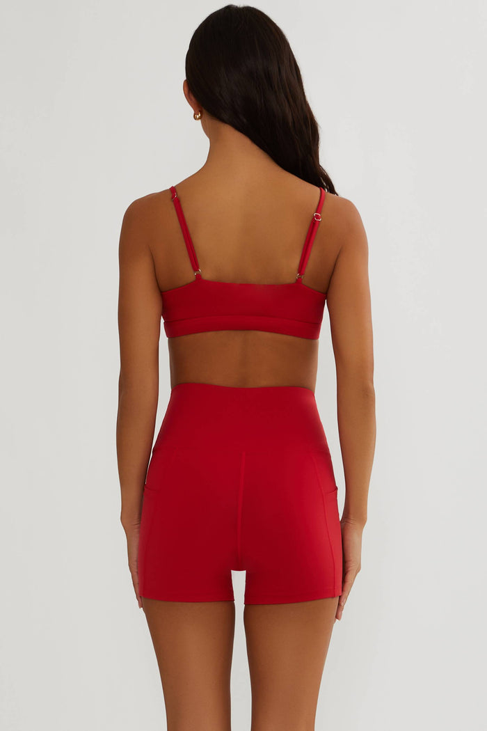 Red two-piece outfit with a bralette and shorts on a white background