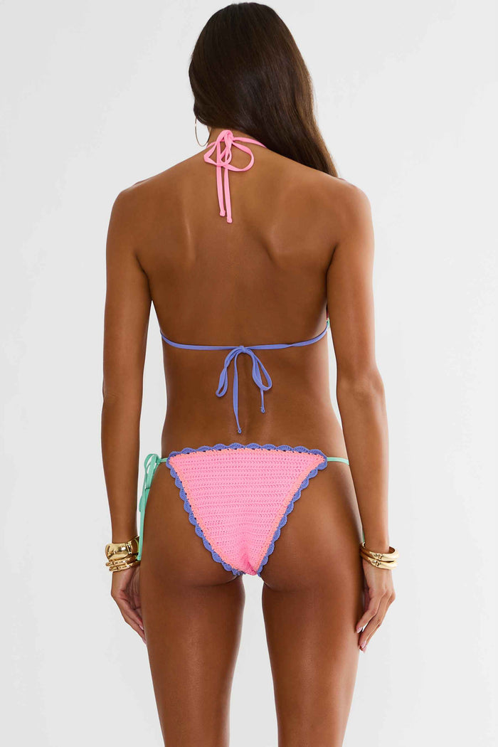 Woman wearing a colorful bikini set on a white background