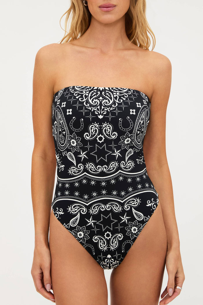 Black and white patterned strapless swimsuit on a model against a white background