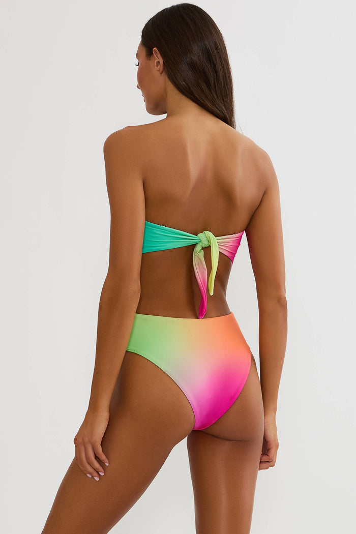 Woman wearing a colorful bikini with a gradient design on a white background