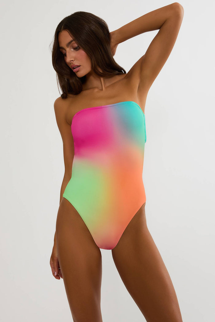 Woman wearing a colorful strapless swimsuit on a white background