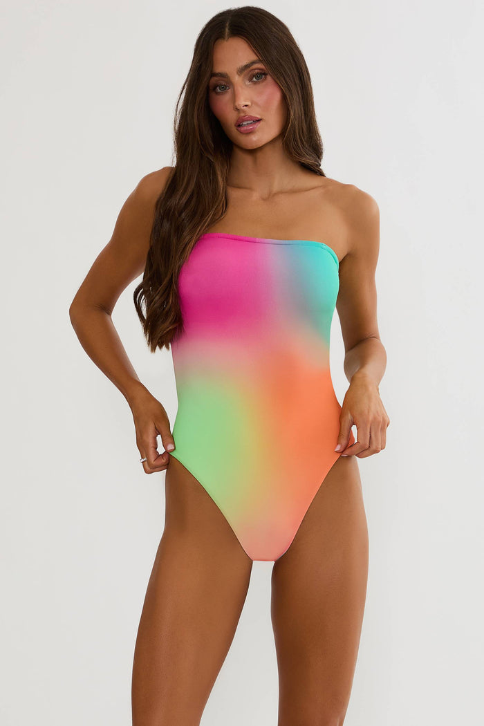 Woman wearing a colorful strapless swimsuit on a white background