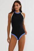 Black swimsuit with blue accents worn by a model on a white background