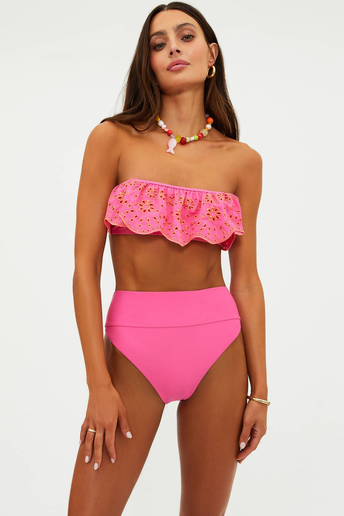 Woman wearing a pink bikini with a white background