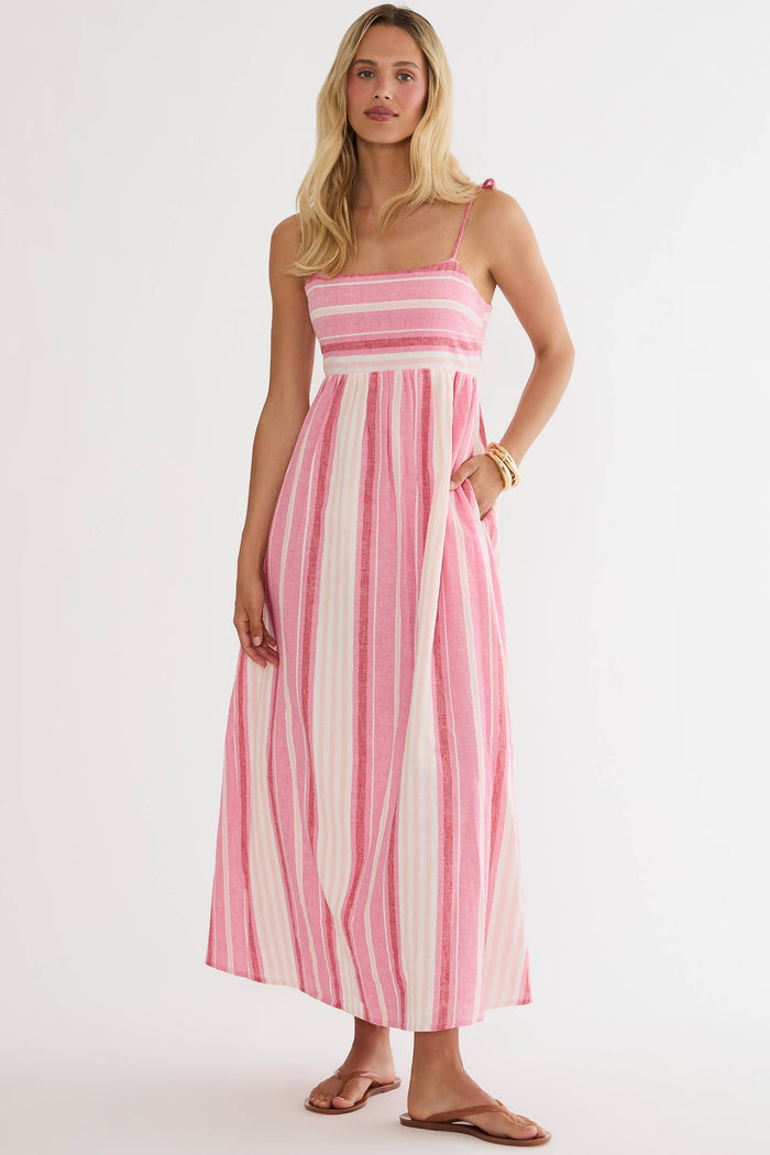 Woman wearing a pink and white striped dress on a white background
