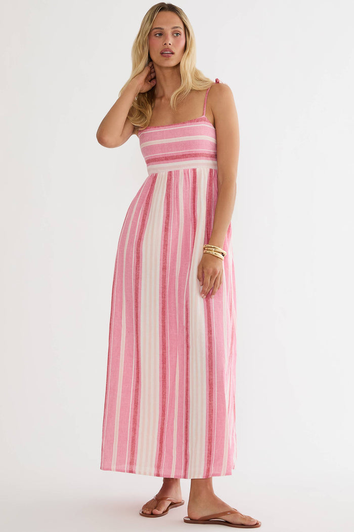 Woman wearing a pink and white striped dress on a white background