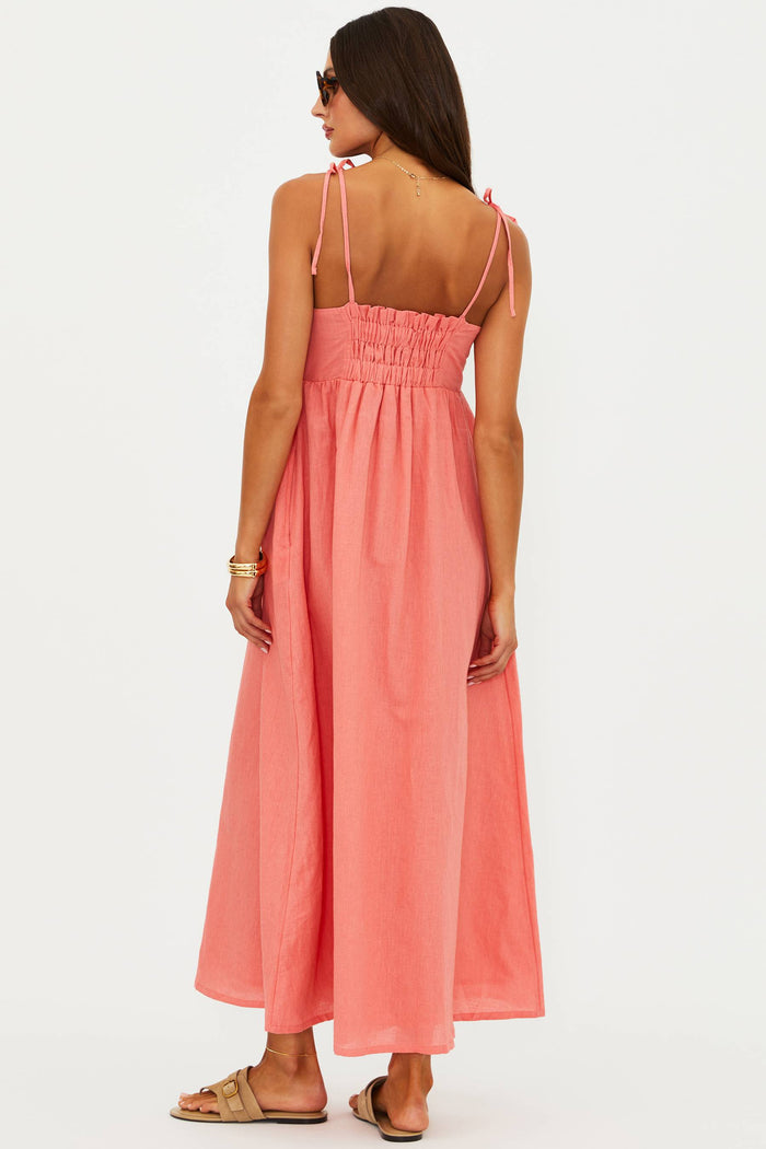 Woman wearing a pink jumpsuit on a white background