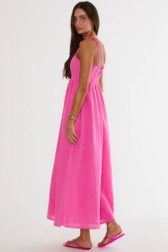Woman wearing a pink dress on a white background