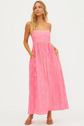 Woman wearing a pink dress on a white background