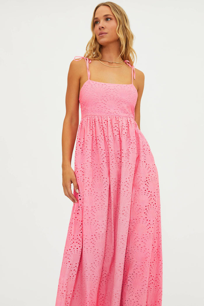Woman wearing a pink dress with a white background