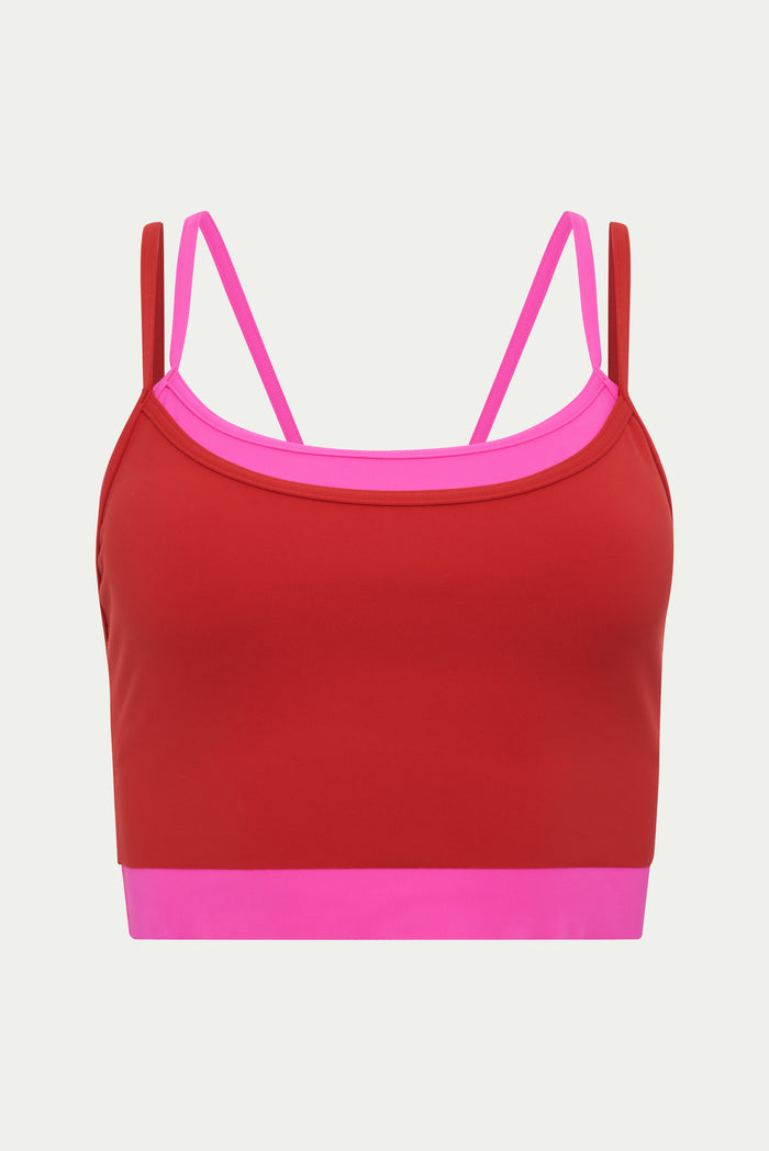 Red sports bra with pink accents on a light gray background