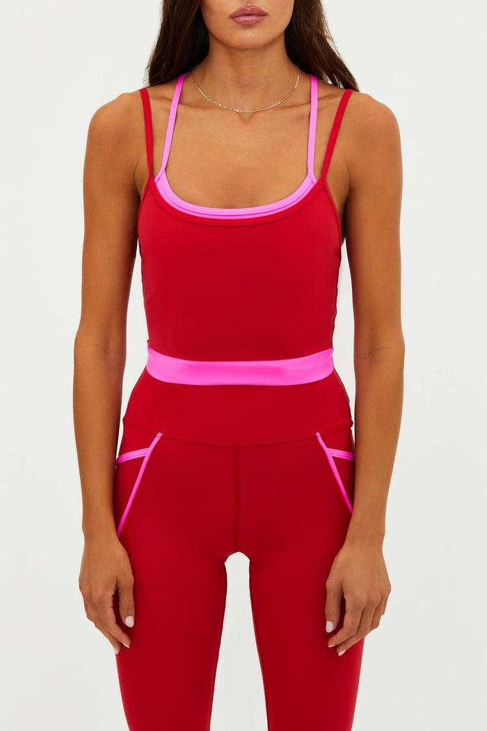 Red athletic outfit with pink accents on a white background