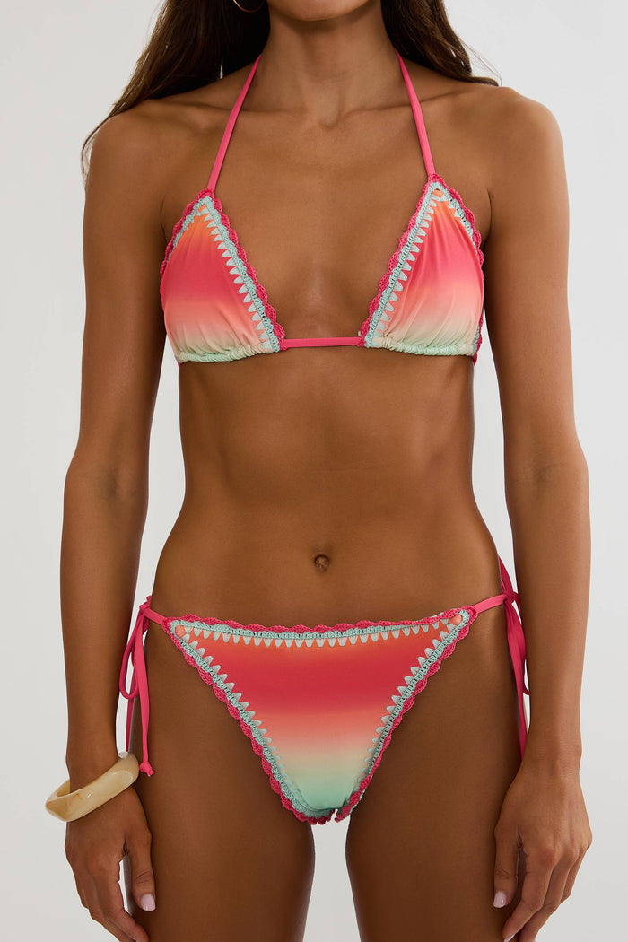 Woman wearing a colorful bikini set on a white background
