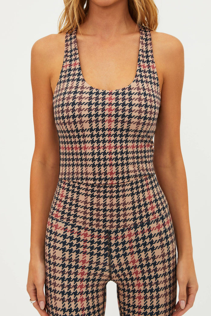 Houndstooth patterned jumpsuit worn by a model on a plain background