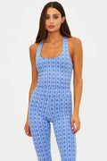 Woman wearing a blue floral jumpsuit on a white background