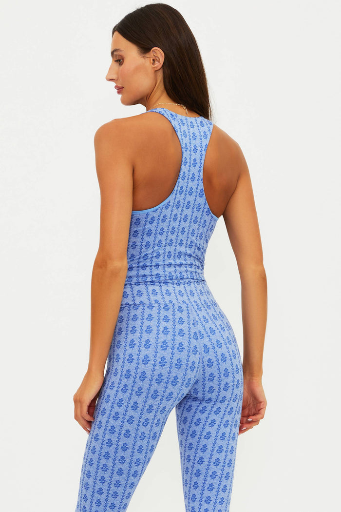 Woman wearing a blue patterned jumpsuit on a white background
