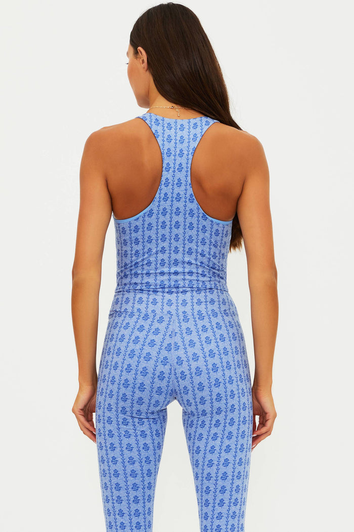 Woman wearing a blue patterned jumpsuit on a white background