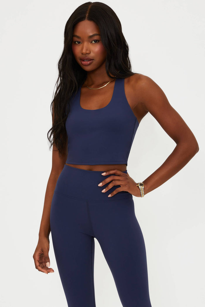Woman wearing a blue athletic outfit on a white background