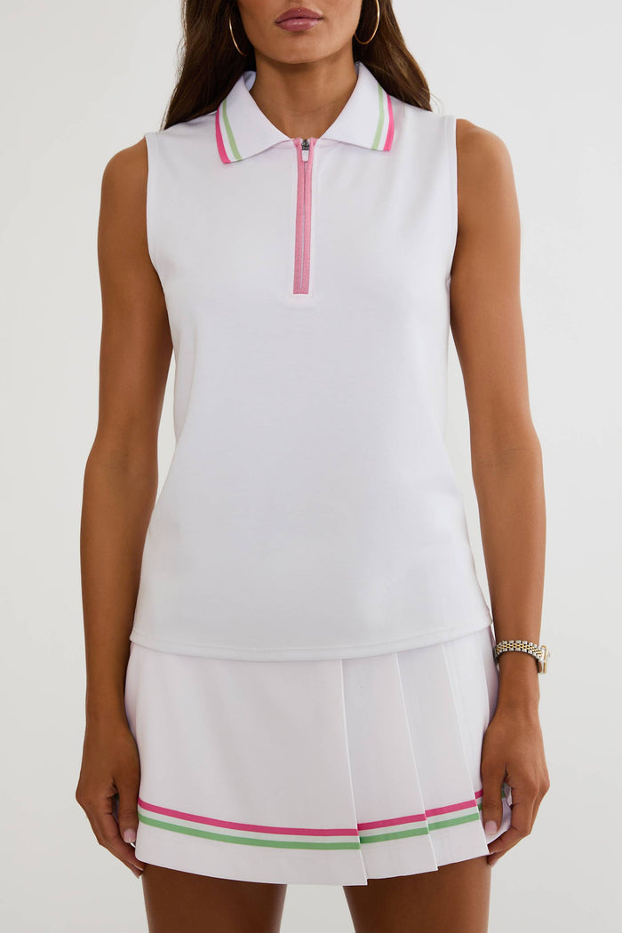 Woman wearing a white sleeveless golf top and skirt with pink and green accents on a white background