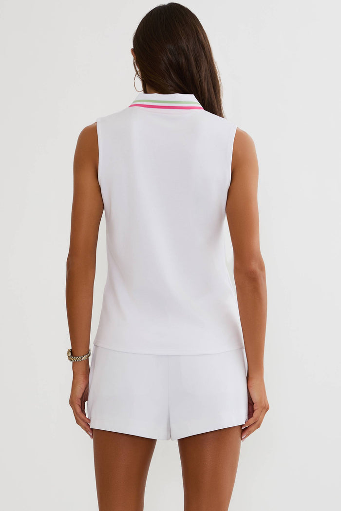 Woman wearing a white sleeveless top and shorts set on a plain background